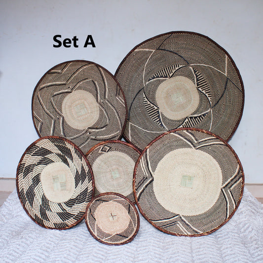 Set of woven baskets with geometric patterns on a white surface