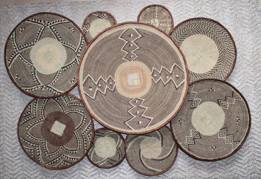 Set of woven baskets with geometric patterns on a textured surface