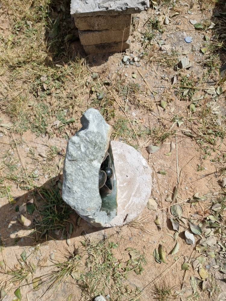 Decorative stone sculpture on a grassy ground